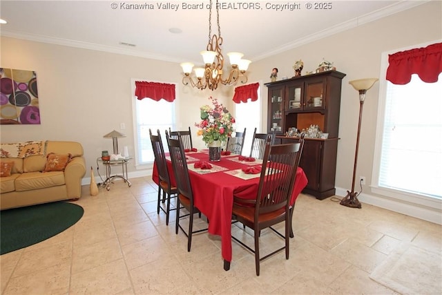 dining room with a notable chandelier and ornamental molding