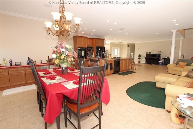 dining area featuring ornate columns, crown molding, and a notable chandelier