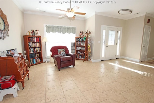 living area featuring ornamental molding, a healthy amount of sunlight, and ceiling fan