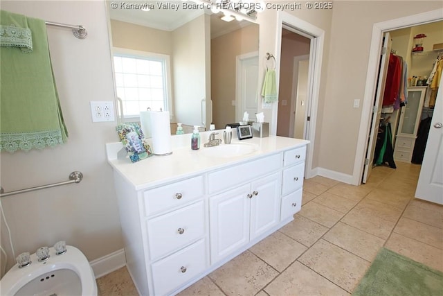 bathroom featuring a bidet, vanity, tile patterned floors, and ornamental molding