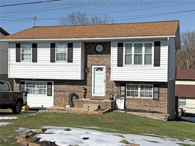 split foyer home with a front lawn