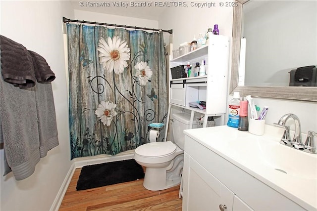 bathroom with vanity, wood-type flooring, toilet, and walk in shower