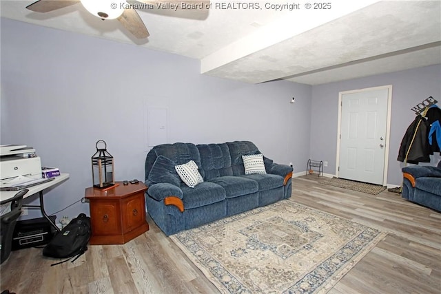 living room featuring ceiling fan and light wood-type flooring