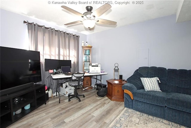 office space featuring ceiling fan and light hardwood / wood-style floors