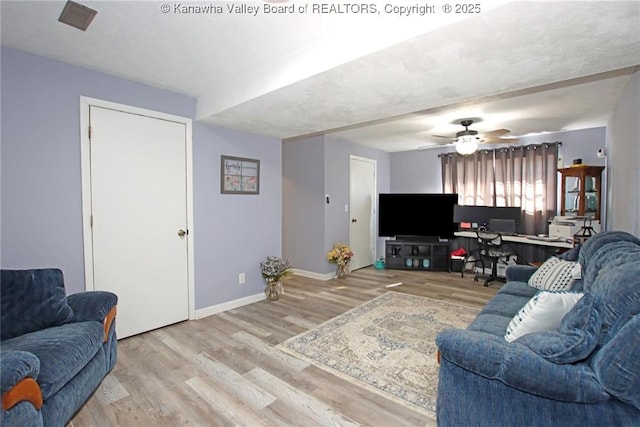 living room featuring ceiling fan and light wood-type flooring