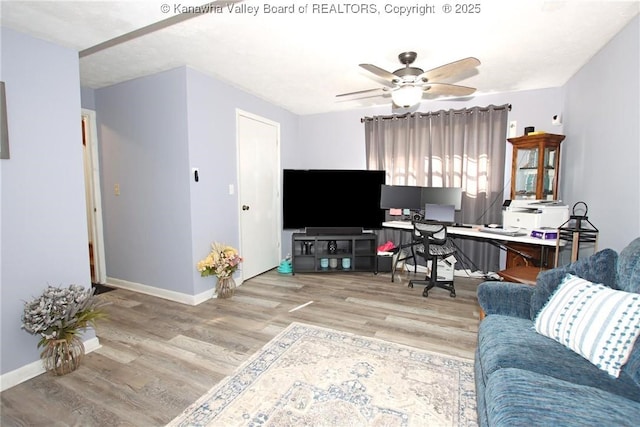 living room featuring hardwood / wood-style flooring and ceiling fan