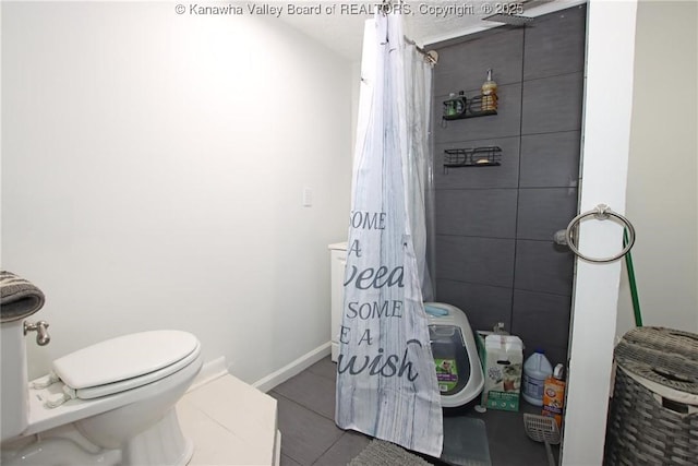 bathroom with tile patterned flooring and toilet