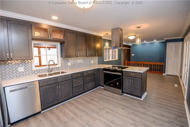 kitchen featuring sink, decorative light fixtures, dark brown cabinets, appliances with stainless steel finishes, and island exhaust hood