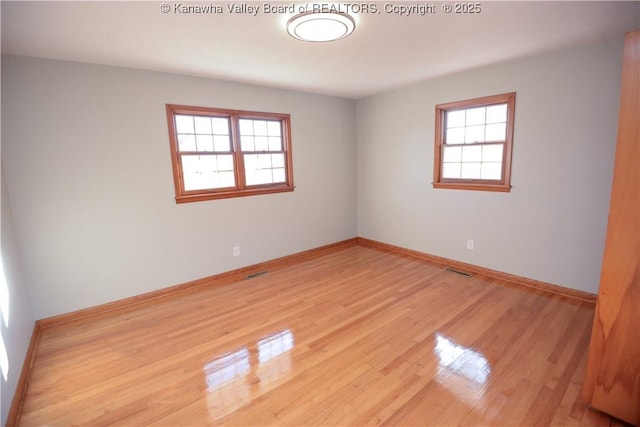 empty room featuring light hardwood / wood-style floors and a healthy amount of sunlight