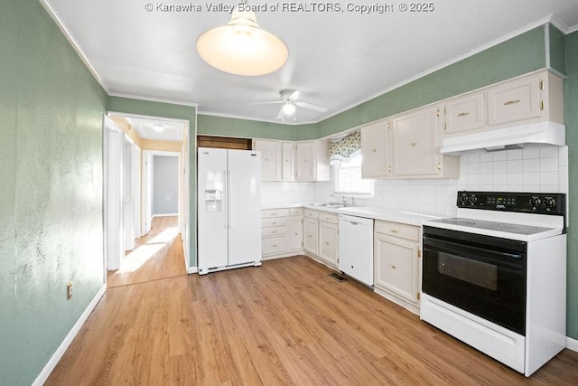 kitchen with tasteful backsplash, white appliances, light hardwood / wood-style flooring, and white cabinets