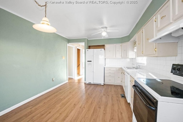 kitchen featuring sink, white appliances, white cabinetry, hanging light fixtures, and decorative backsplash