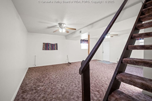 basement with ceiling fan and carpet flooring