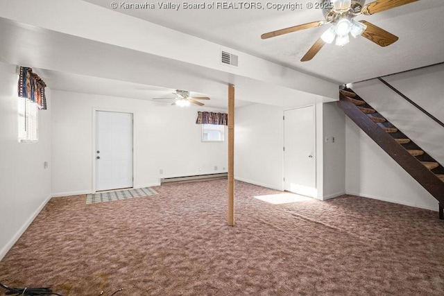 basement with ceiling fan, carpet, and baseboard heating