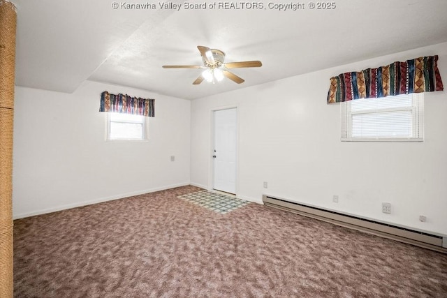 carpeted spare room with a baseboard radiator and ceiling fan