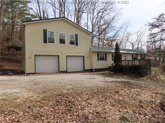 view of front of house featuring a garage and a wooden deck