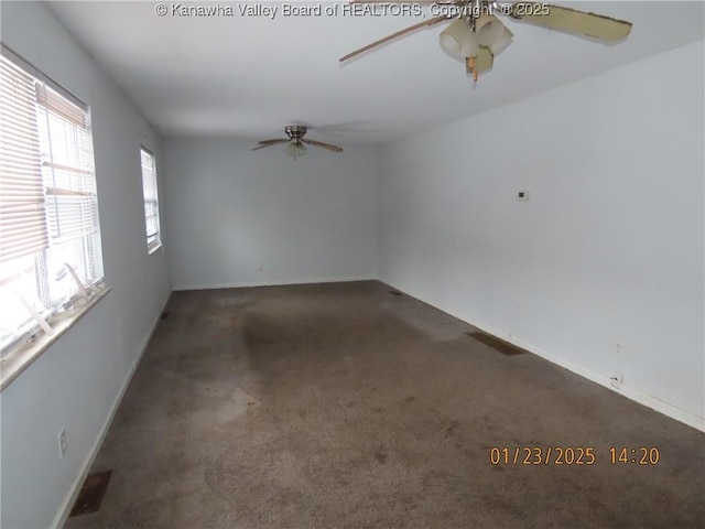 empty room featuring dark colored carpet and ceiling fan