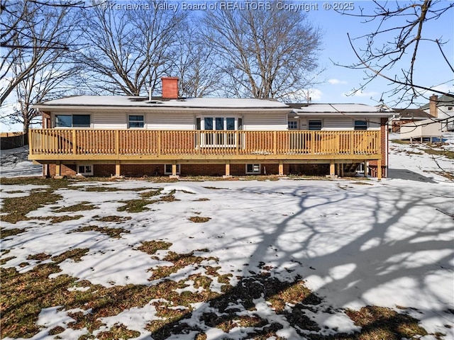 snow covered property with a deck