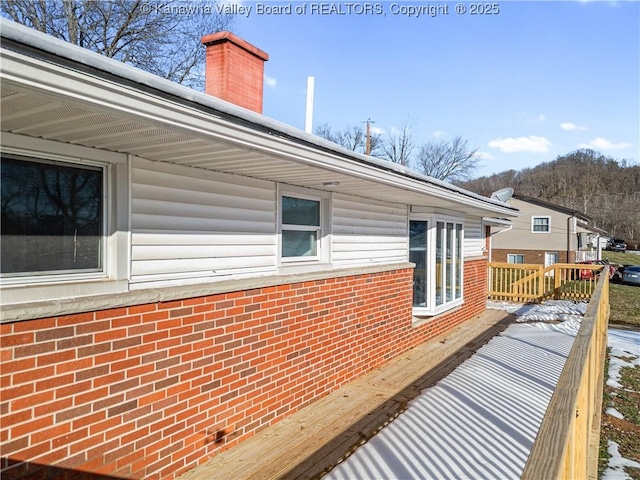 view of property exterior with a wooden deck