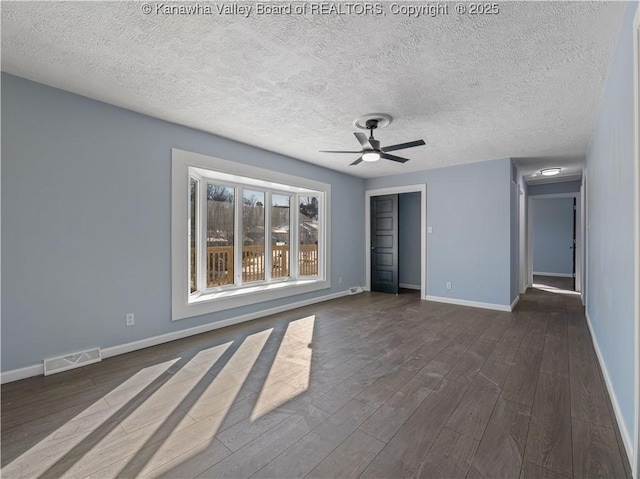 unfurnished room with dark hardwood / wood-style floors, a textured ceiling, and ceiling fan