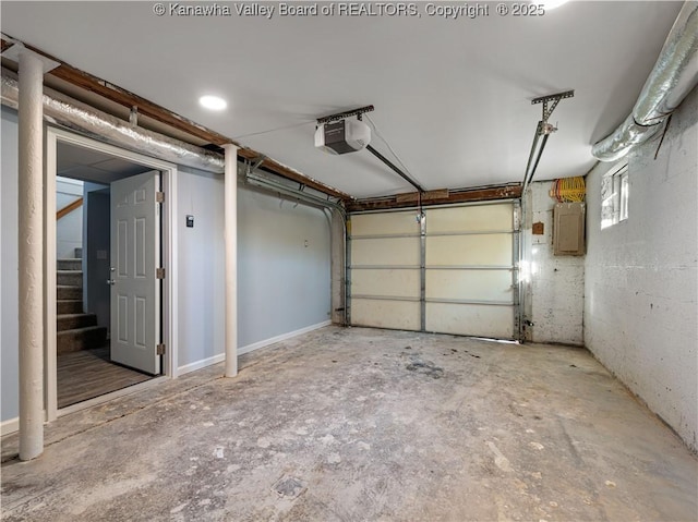 garage with a garage door opener and electric panel