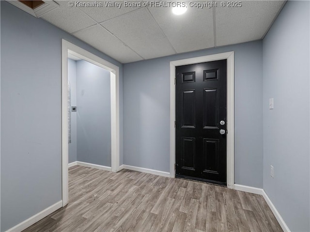 foyer featuring light hardwood / wood-style floors and a drop ceiling