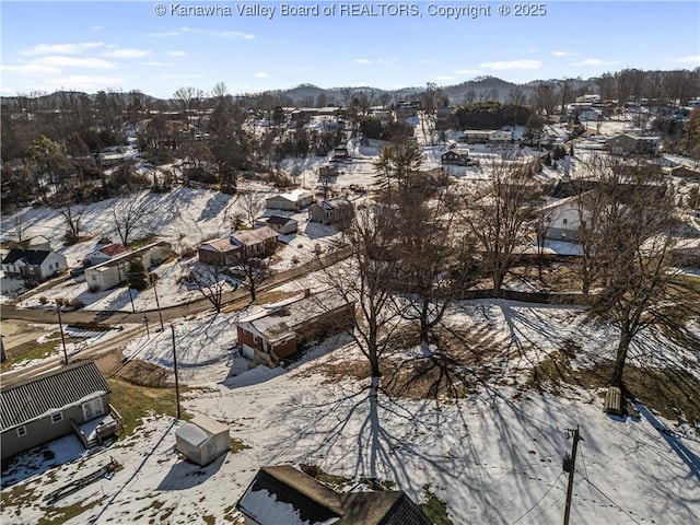 snowy aerial view featuring a mountain view