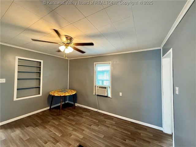 spare room featuring ornamental molding, dark wood-type flooring, ceiling fan, and built in shelves