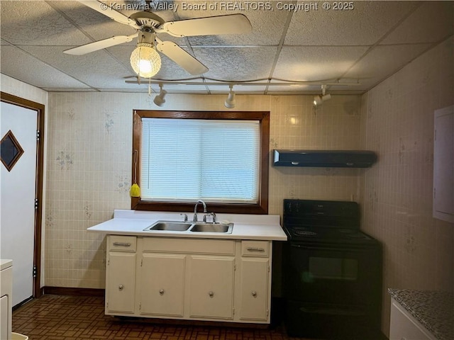 kitchen with sink, a paneled ceiling, ceiling fan, white cabinetry, and black range with electric stovetop