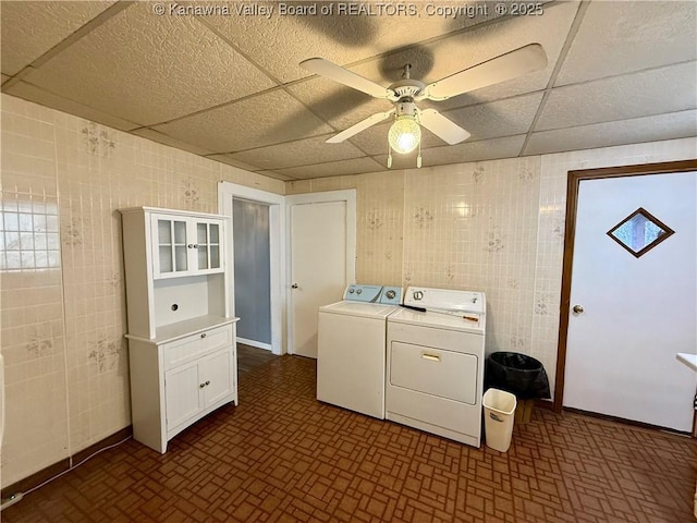 laundry area featuring separate washer and dryer, tile walls, and ceiling fan