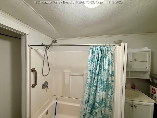 bathroom featuring shower / bath combo with shower curtain, vanity, and a textured ceiling