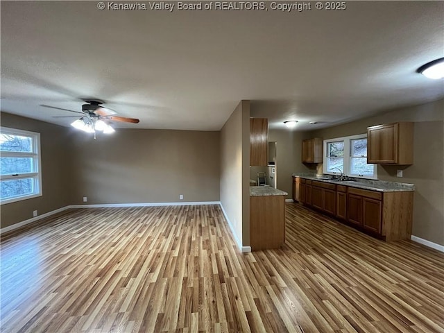 kitchen featuring sink, light hardwood / wood-style floors, and ceiling fan