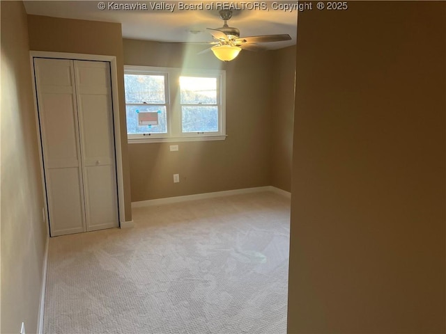 unfurnished bedroom featuring light carpet, a closet, and ceiling fan