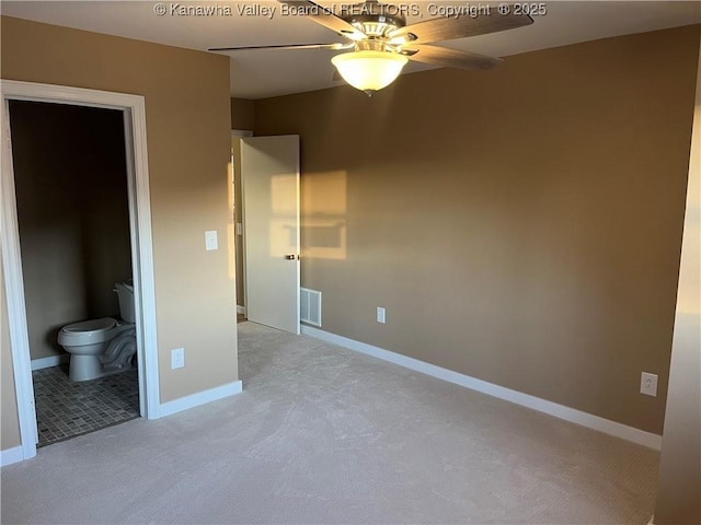 unfurnished bedroom with ensuite bathroom and light colored carpet