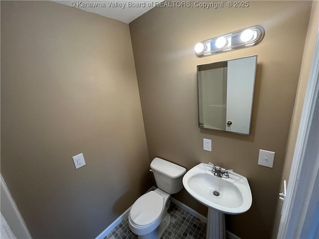 bathroom with tile patterned flooring, sink, and toilet