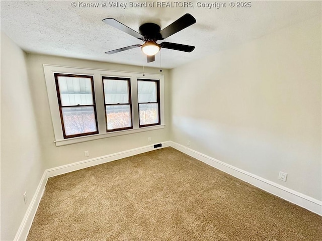 unfurnished room featuring ceiling fan, carpet floors, and a textured ceiling