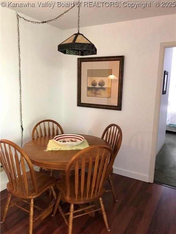 dining room with dark wood-type flooring