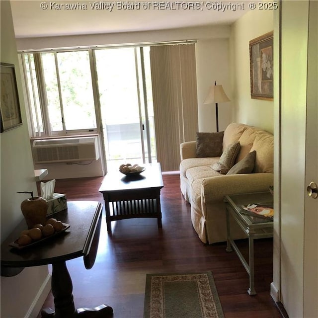 living room featuring cooling unit and dark hardwood / wood-style floors