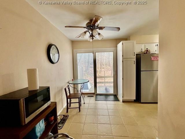 interior space with ceiling fan and light tile patterned floors