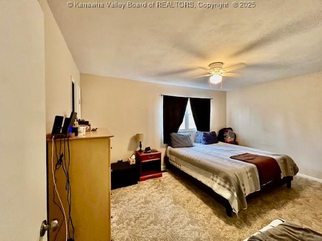 bedroom featuring ceiling fan and carpet