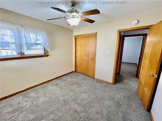 unfurnished bedroom featuring a closet, ceiling fan, and dark colored carpet