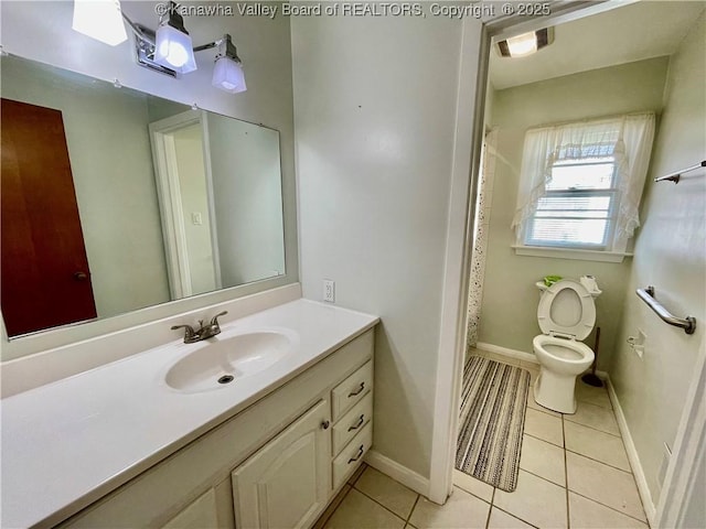 bathroom featuring tile patterned flooring, vanity, and toilet