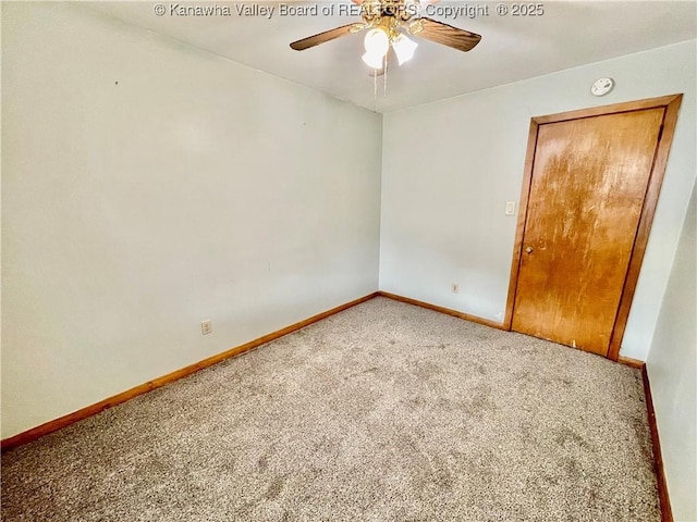 spare room featuring ceiling fan and carpet floors