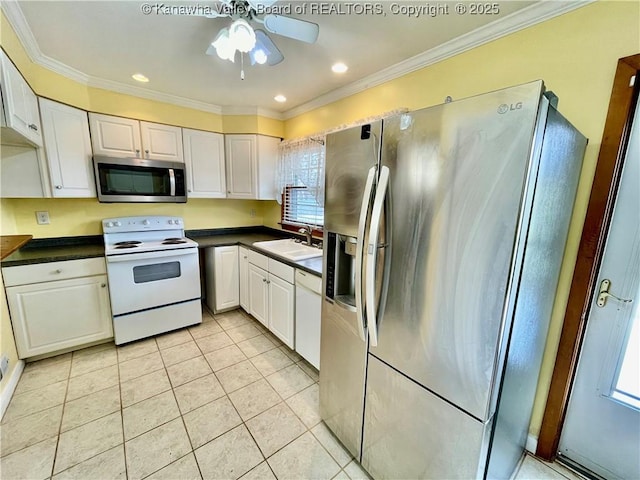 kitchen with sink, light tile patterned floors, stainless steel appliances, and white cabinets