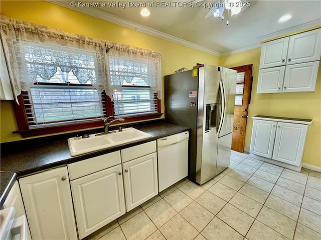 kitchen featuring white cabinetry, dishwasher, sink, and stainless steel fridge