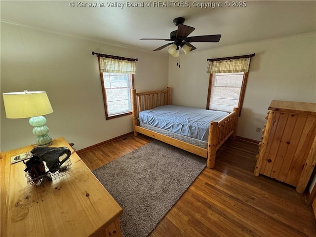 bedroom with crown molding, dark wood-type flooring, and ceiling fan