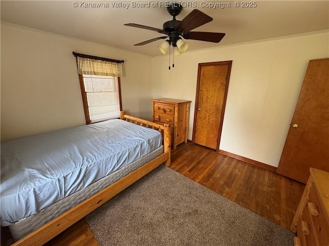 unfurnished bedroom with dark hardwood / wood-style flooring, ornamental molding, and ceiling fan