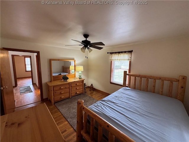 bedroom with hardwood / wood-style floors and ceiling fan