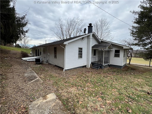 back of house featuring central AC