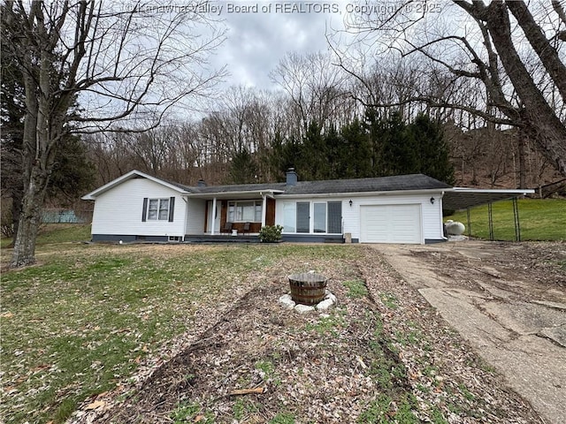 ranch-style house featuring a garage, a carport, and a front yard