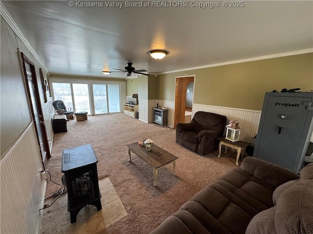 living room with crown molding, light carpet, and ceiling fan